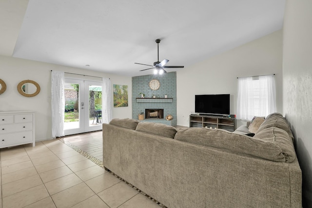 living area with french doors, ceiling fan, light tile patterned flooring, and a healthy amount of sunlight