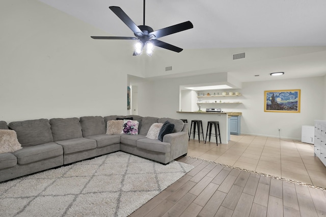 living room with high vaulted ceiling, baseboards, a ceiling fan, and visible vents
