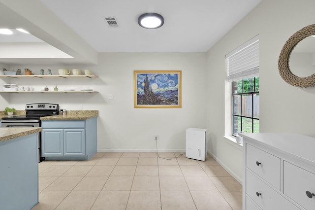 kitchen featuring electric range, visible vents, open shelves, light countertops, and baseboards