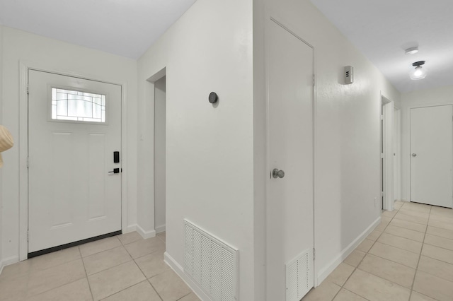 foyer entrance with visible vents, baseboards, and light tile patterned flooring