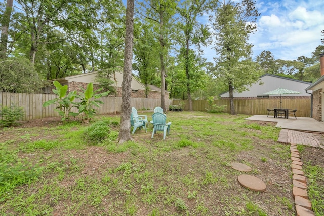 view of yard with a fenced backyard and a patio area