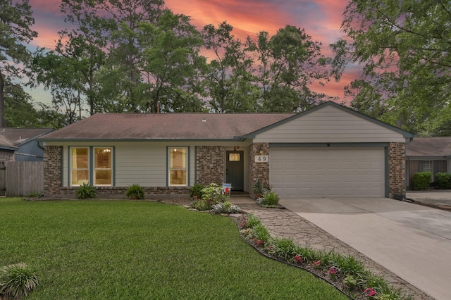 ranch-style home featuring an attached garage, concrete driveway, and brick siding