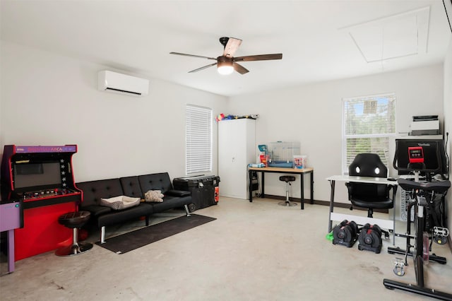 interior space featuring an AC wall unit, ceiling fan, concrete floors, and attic access