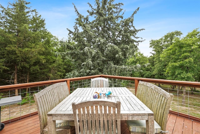 wooden deck featuring outdoor dining area