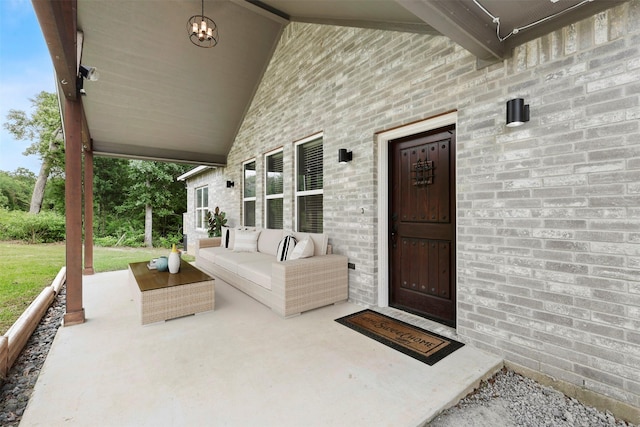 24 Hickory Ridge Dr, Hilltop Lakes, TX 77871 - view of exterior entry with outdoor lounge area and brick siding