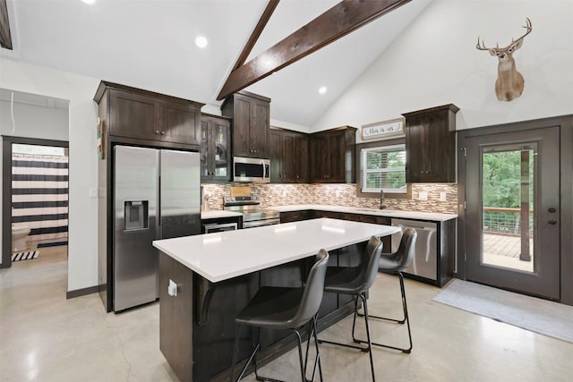 kitchen with tasteful backsplash, stainless steel appliances, finished concrete floors, and dark brown cabinets