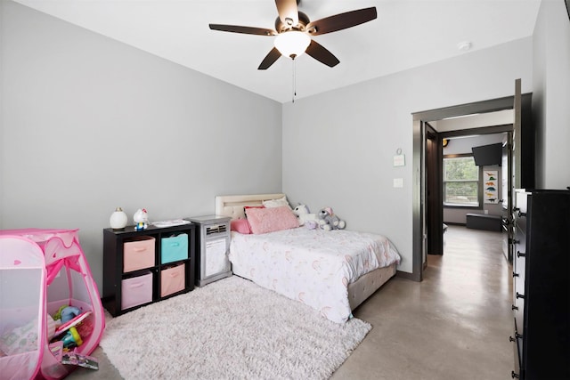 bedroom with a ceiling fan and finished concrete flooring
