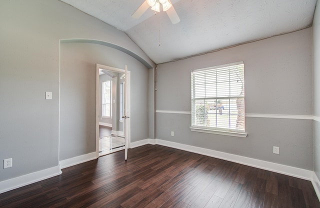 unfurnished room featuring wood-type flooring, ceiling fan, vaulted ceiling, and a healthy amount of sunlight