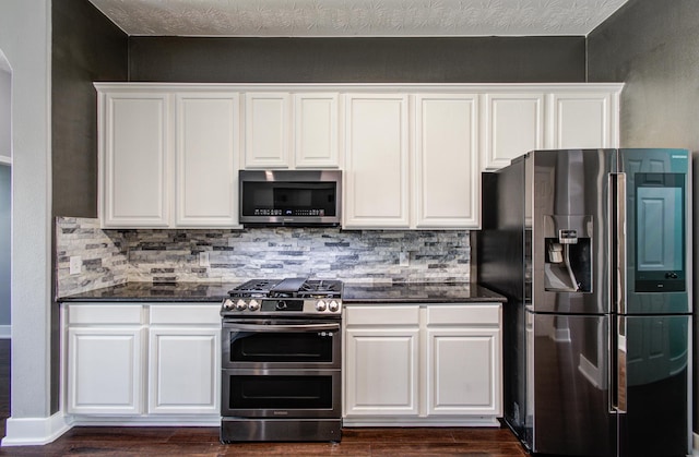 kitchen featuring dark wood finished floors, tasteful backsplash, and stainless steel appliances