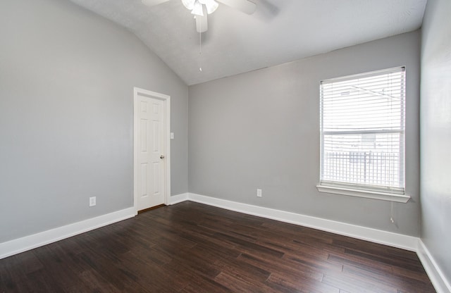 empty room featuring baseboards, dark wood-type flooring, ceiling fan, and lofted ceiling