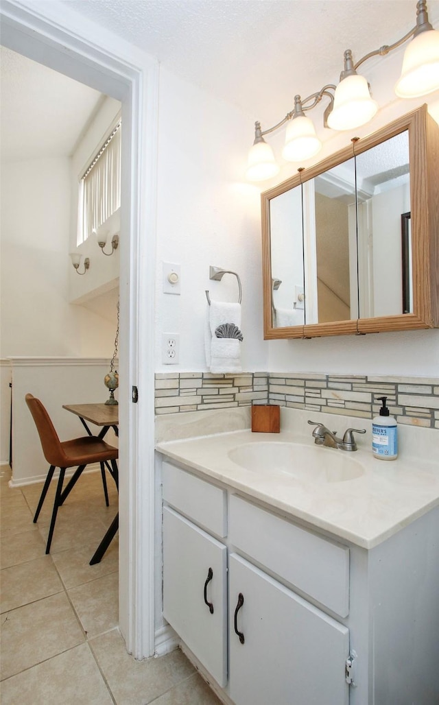 bathroom featuring tile patterned flooring and vanity