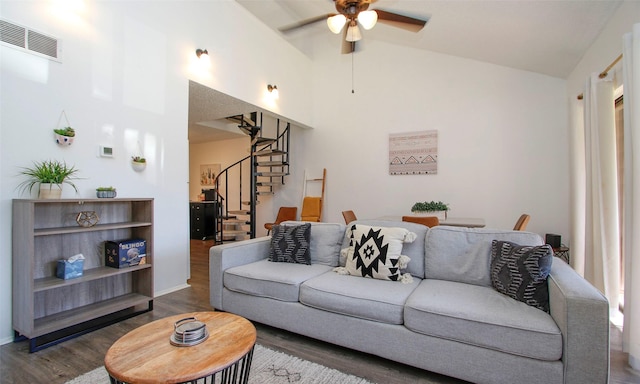 living area featuring a ceiling fan, dark wood-style flooring, visible vents, high vaulted ceiling, and stairs