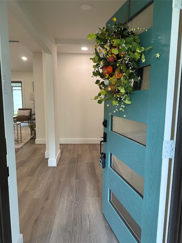 foyer entrance featuring baseboards, recessed lighting, and wood finished floors