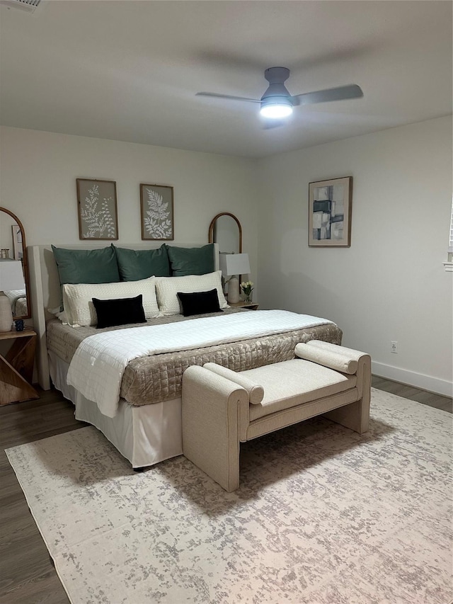 bedroom featuring baseboards, ceiling fan, and wood finished floors