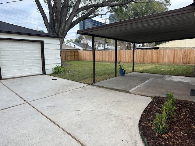 view of patio / terrace featuring a fenced backyard, concrete driveway, and a garage