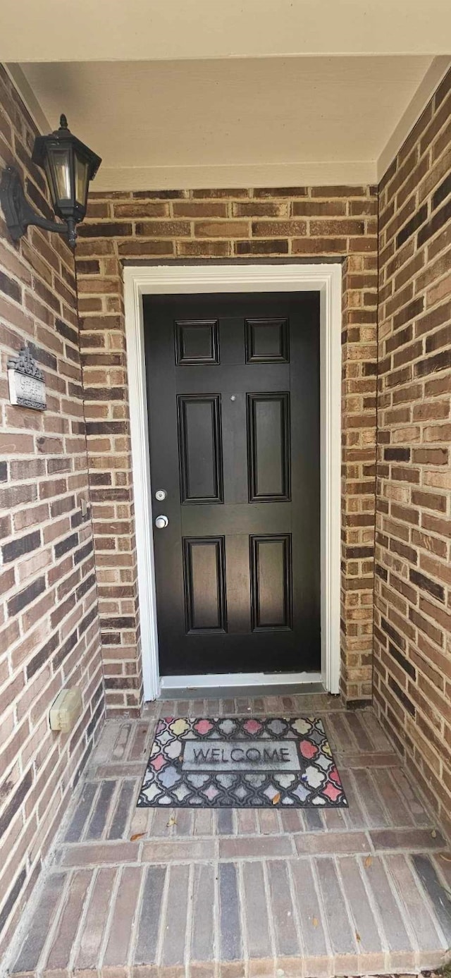 entrance to property with brick siding