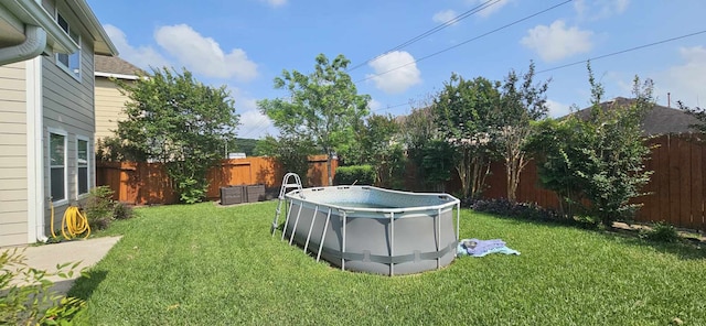view of yard featuring a fenced in pool and a fenced backyard