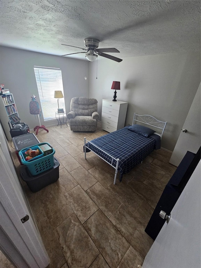 bedroom with a textured ceiling and ceiling fan