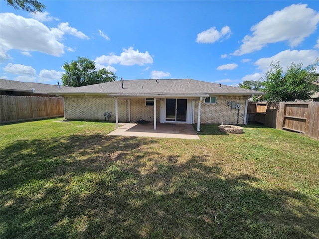 rear view of property with a patio, a fenced backyard, and a lawn