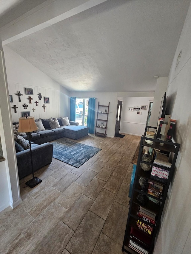 living room with vaulted ceiling and a textured ceiling