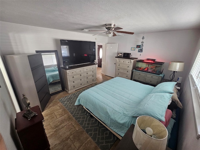 bedroom featuring a textured ceiling and ceiling fan