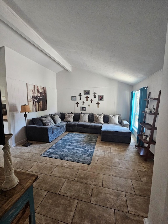 living area with vaulted ceiling with beams and a textured ceiling