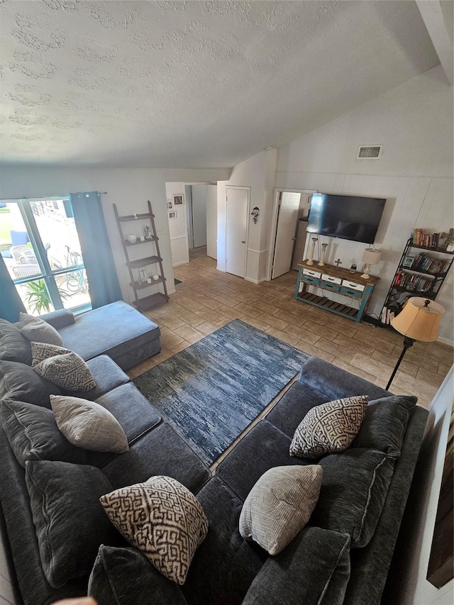 living room with a textured ceiling and visible vents