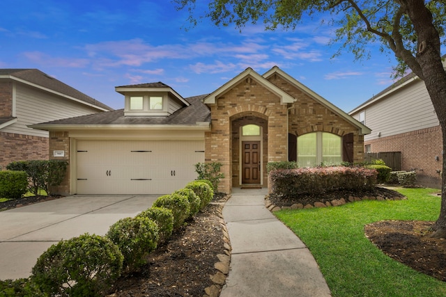 traditional home featuring a garage, a front lawn, brick siding, a shingled roof, and driveway