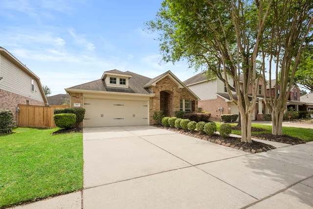 traditional-style house with roof with shingles, fence, brick siding, a front yard, and driveway