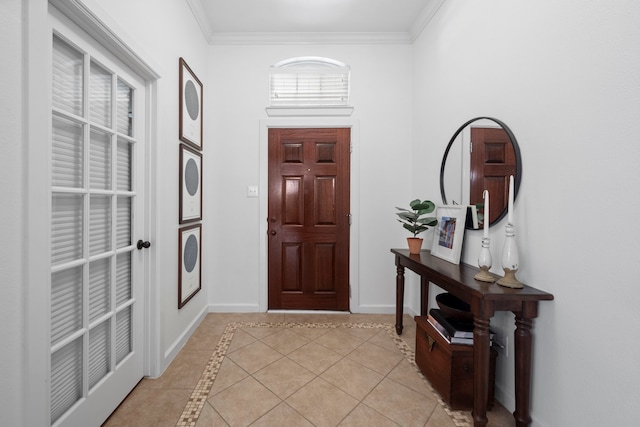 entrance foyer featuring light tile patterned floors, baseboards, and crown molding