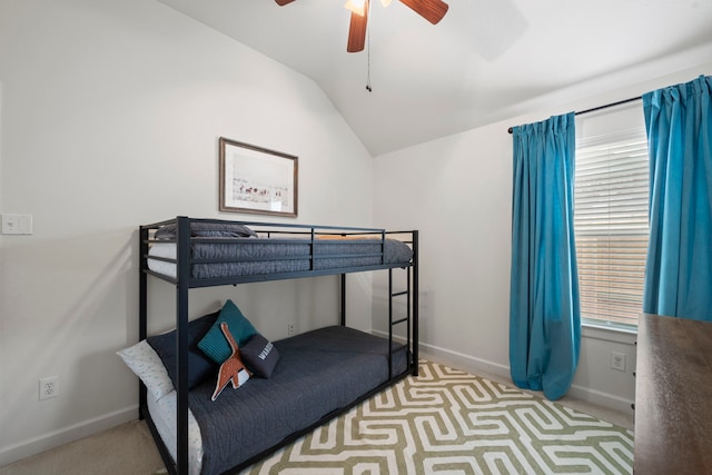 unfurnished bedroom with a ceiling fan, baseboards, and vaulted ceiling