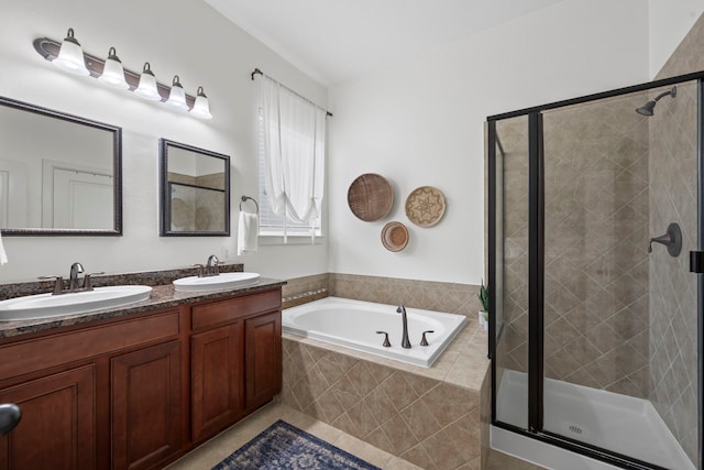 bathroom with double vanity, a sink, a bath, and a stall shower