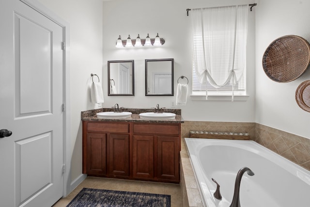 bathroom with a sink, a garden tub, and double vanity
