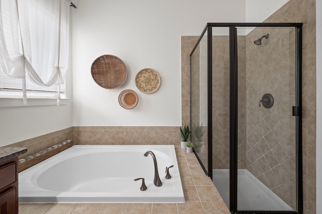 bathroom with vanity, a garden tub, and a stall shower