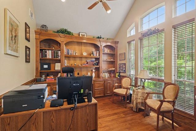 office featuring ceiling fan, visible vents, wood finished floors, and high vaulted ceiling