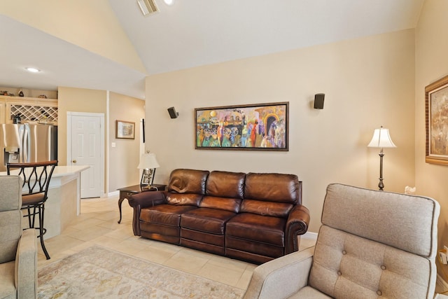 living room with visible vents, baseboards, light tile patterned floors, and high vaulted ceiling