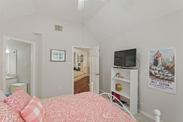 bedroom featuring ceiling fan, visible vents, vaulted ceiling, baseboards, and ensuite bathroom