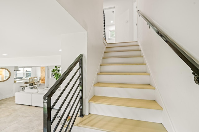 stairway featuring tile patterned flooring and recessed lighting