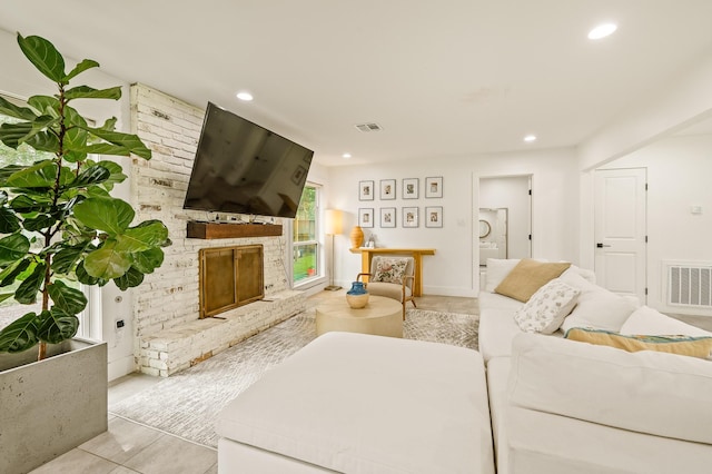 living area with tile patterned flooring, a fireplace, recessed lighting, and visible vents