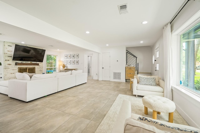 living room featuring visible vents, recessed lighting, stairs, and light tile patterned floors