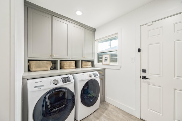 laundry area with baseboards, recessed lighting, light wood-type flooring, cabinet space, and independent washer and dryer