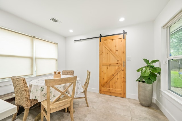 dining space featuring visible vents, a barn door, plenty of natural light, and recessed lighting