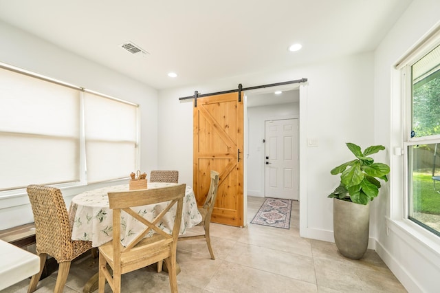 dining room with visible vents, a barn door, a wealth of natural light, and recessed lighting