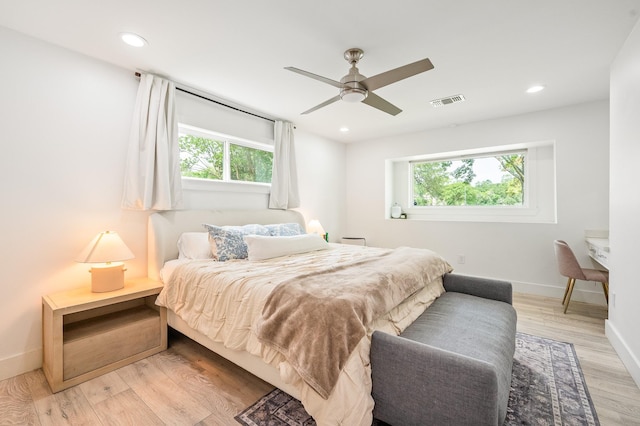 bedroom with light wood-style floors, baseboards, recessed lighting, and visible vents