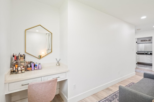 hall featuring recessed lighting, light wood finished floors, and baseboards