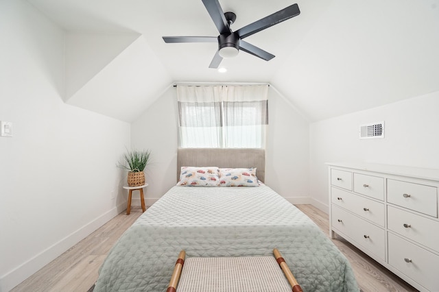 bedroom with visible vents, light wood-style floors, baseboards, a ceiling fan, and vaulted ceiling