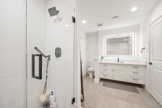 bathroom featuring visible vents, a stall shower, vanity, toilet, and recessed lighting