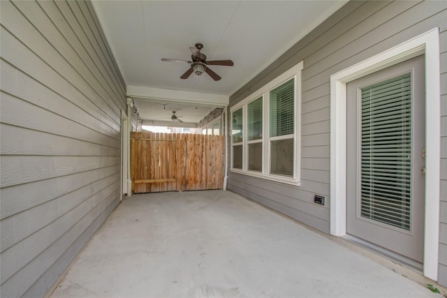 view of patio featuring fence and a ceiling fan