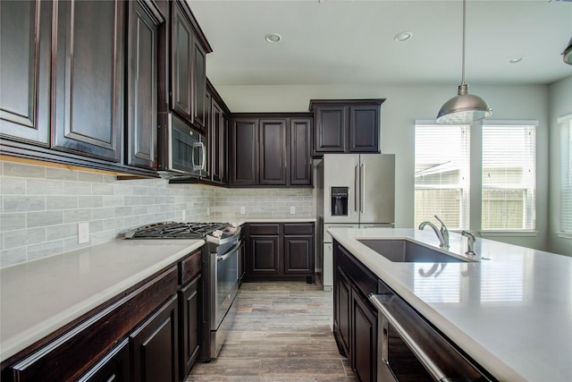 kitchen with light countertops, stainless steel appliances, and a sink