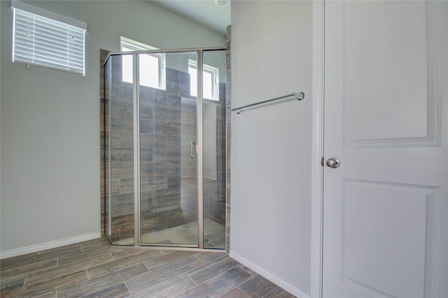 full bathroom with baseboards, wood tiled floor, and a shower stall
